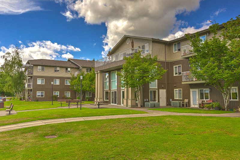 Building exterior and green grass | Vintage at Arlington Senior Apts for rent - Photo Gallery 1