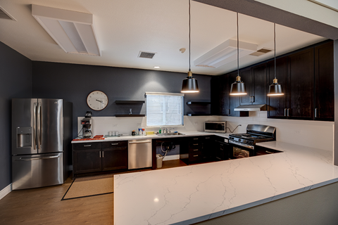 a kitchen with a white counter top and a refrigerator