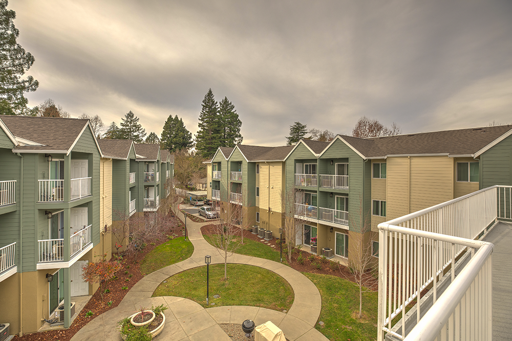 View of exterior of community with grass l Vintage at Napa Senior Apartments