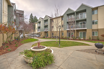 View of exterior of community with grass l Vintage at Napa Senior Apartments - Photo Gallery 5