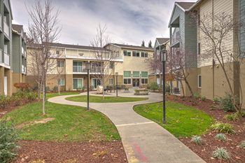 View of exterior of community with grass l Vintage at Napa Senior Apartments - Photo Gallery 6
