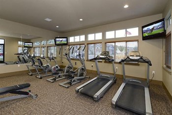 Gym with Fitness equipment and TVs Longmont, CO 99337 | Copper Peak Apts For Rent - Photo Gallery 11