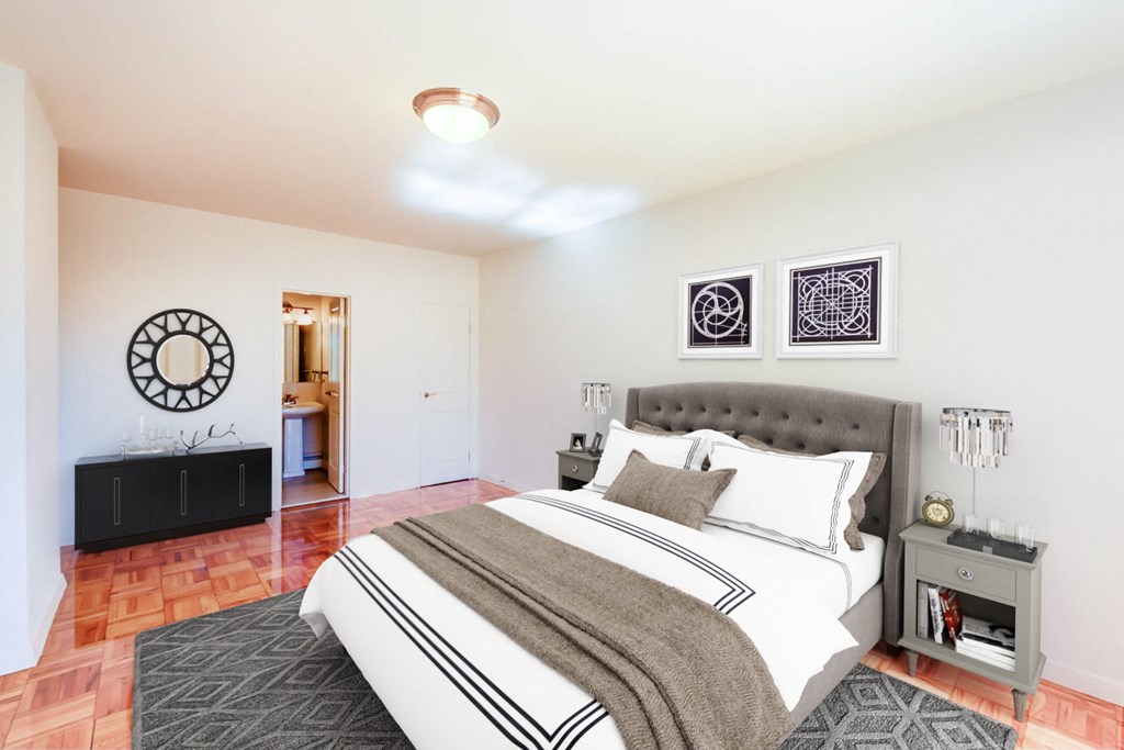 bedroom with bed, nightstands, dresser and hardwood flooring at clarence house apartments in washington dc