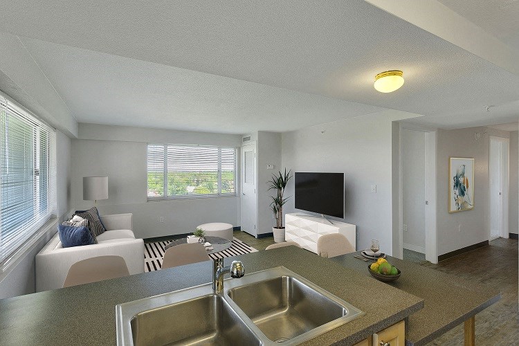 a kitchen and living room of an apartment