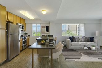 a kitchen and living room with stainless steel appliances and a table