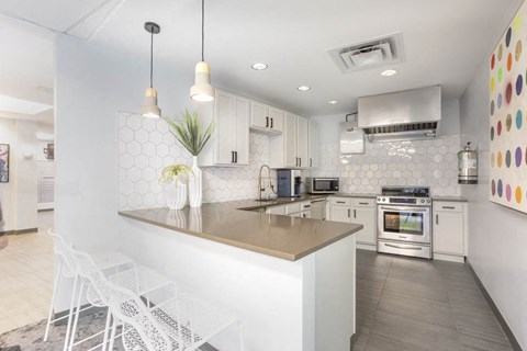 a kitchen with white cabinets and a counter top
