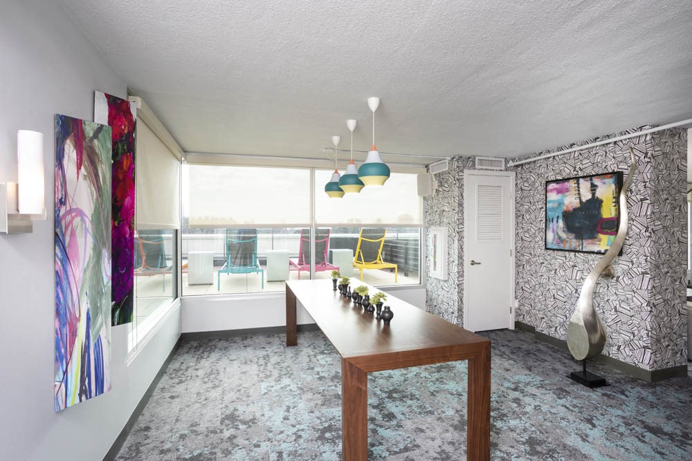 a dining room with a wooden table and a large window