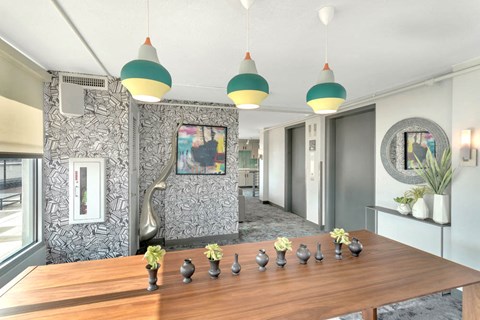a dining room with a wooden table and vases