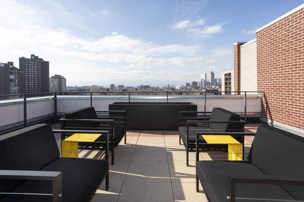 a rooftop patio with a view of the city