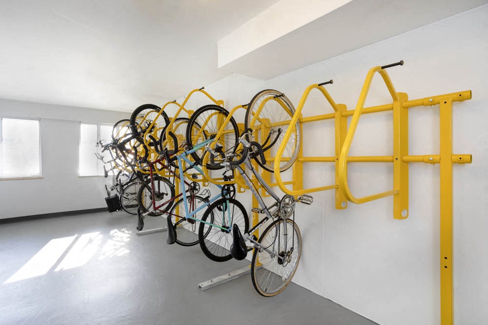 a row of bikes hanging on a wall in a room