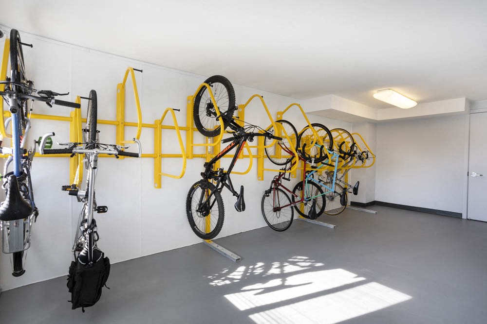 the bikes are hanging on the wall in a room