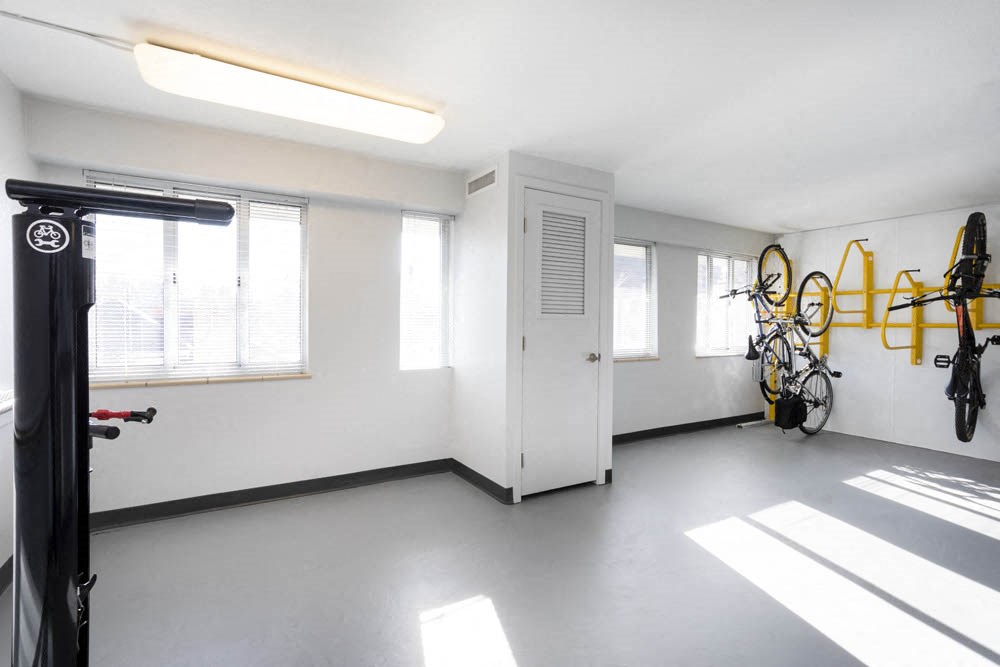 a white room with bikes on the wall and a white door