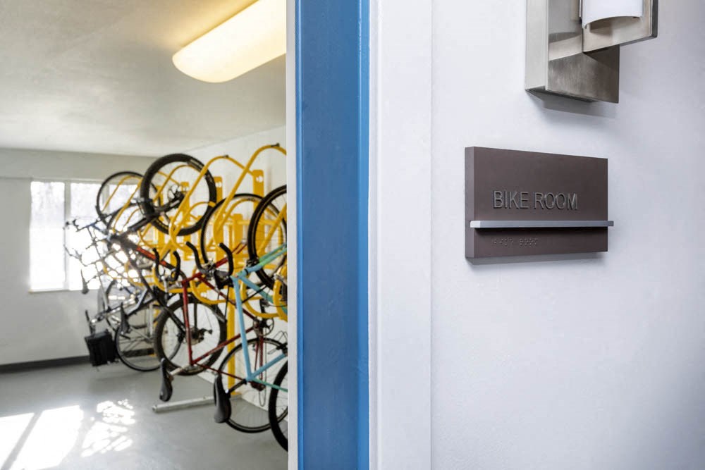 a rack of bikes in a room with a sign on the wall