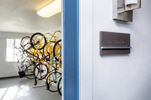 a rack of bikes in a room with a sign on the wall