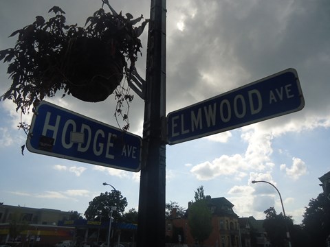 two street signs on a pole next to a street light