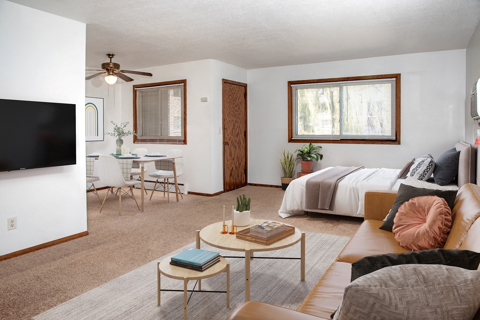 a living room with a couch and a table and a bed