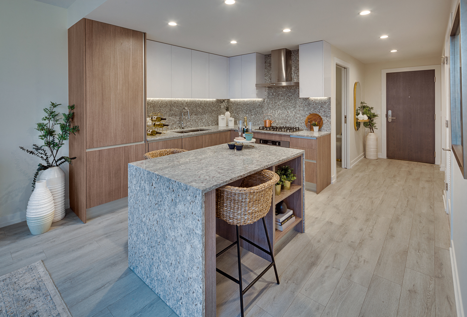 a kitchen with a large island and wooden cabinets