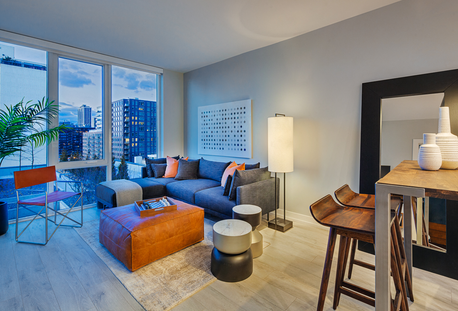 a living room with a blue couch and a large window