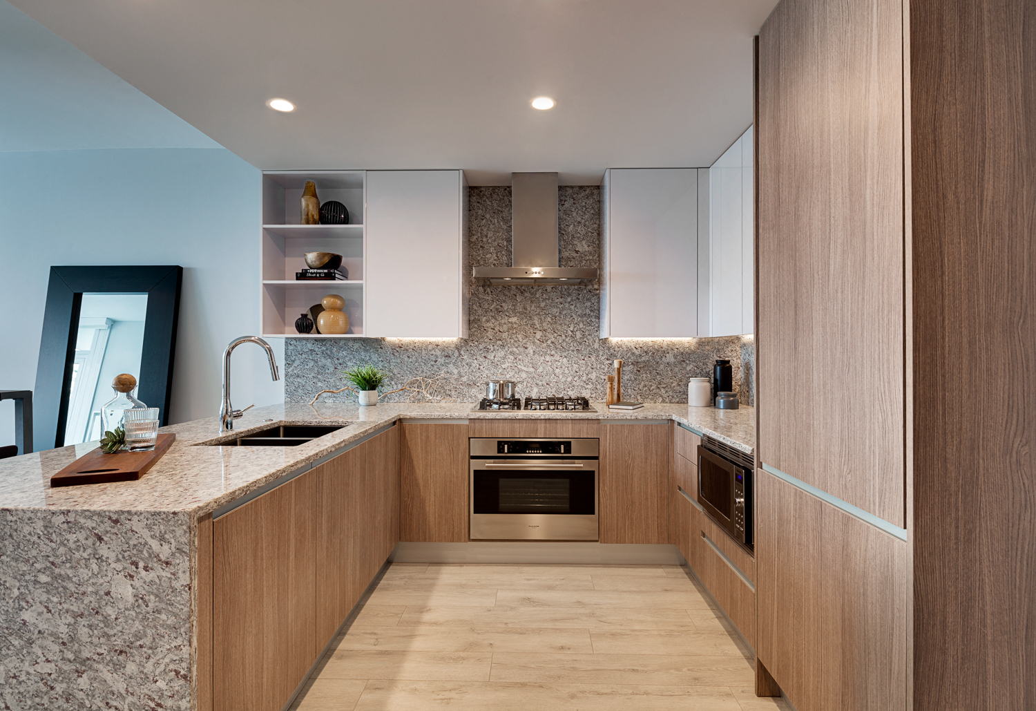 a kitchen with wooden cabinets and granite counter tops