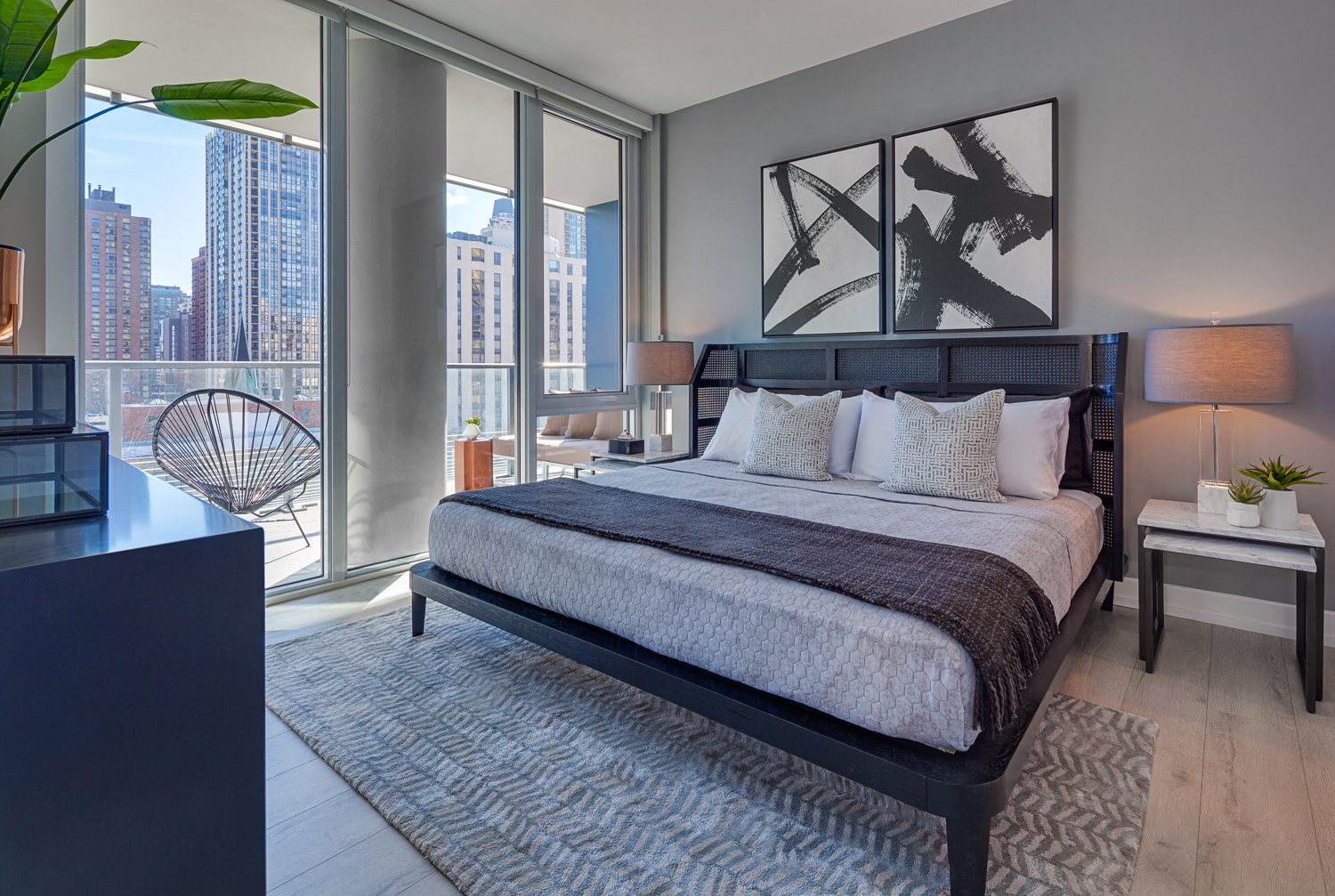 a bedroom with a bed and a view of the city