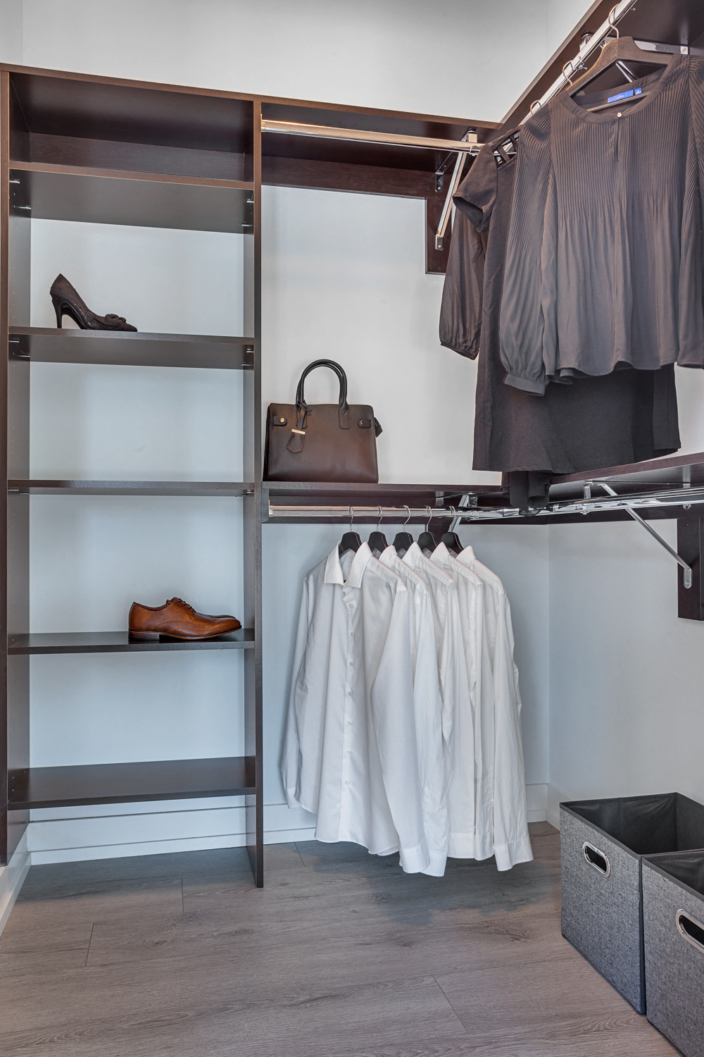 a walk in closet with shelves filled with clothes and shoes