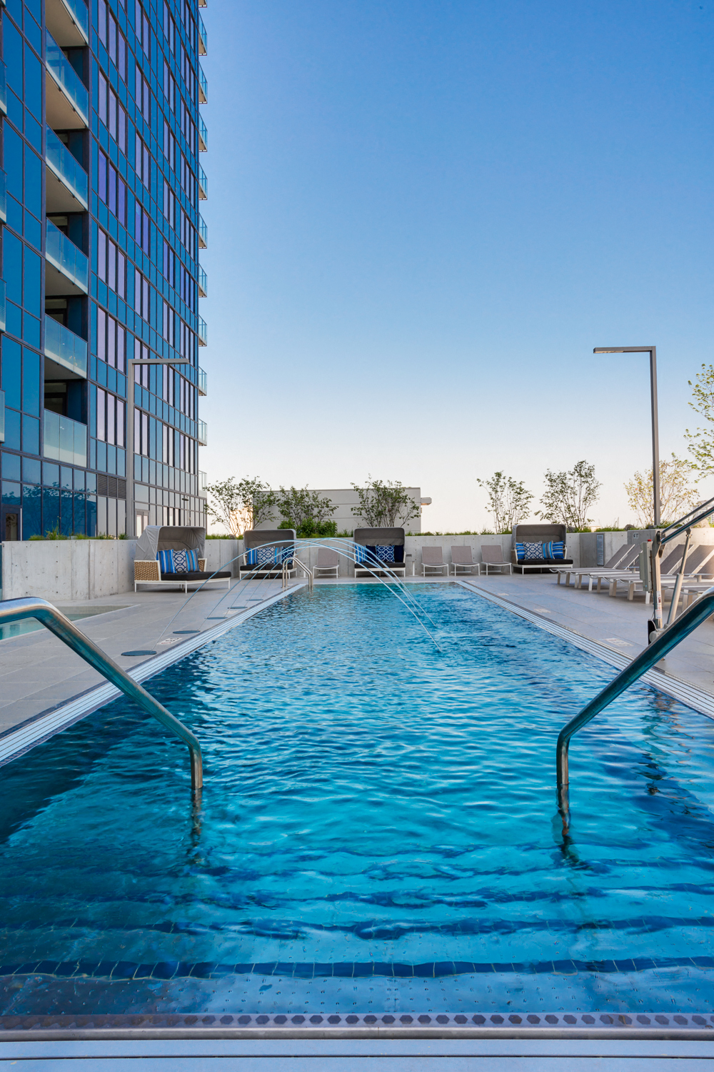 a swimming pool in front of a tall building