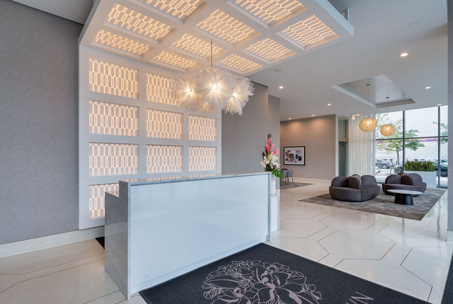 a lobby with a reception desk and a large window