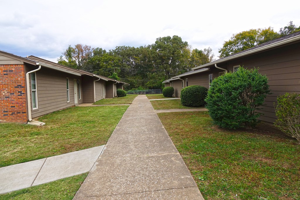 a sidewalk in front of a row of houses