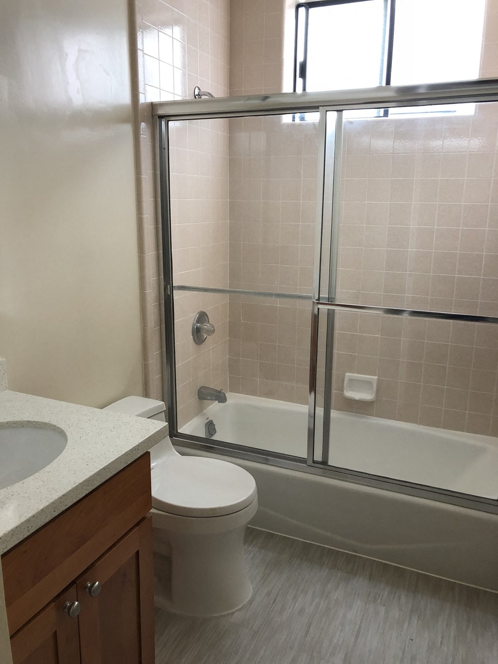 a bathroom with a shower and a toilet and a sink