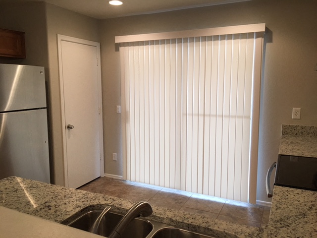 a kitchen with a window and a sink and a refrigerator