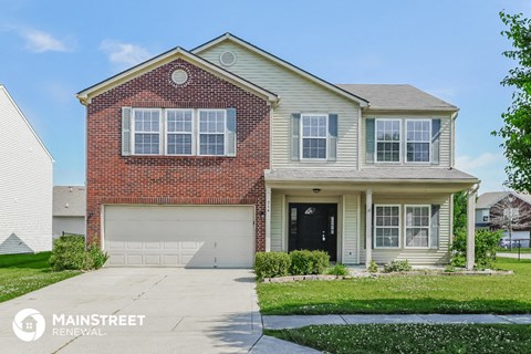 a brick house with a white garage door