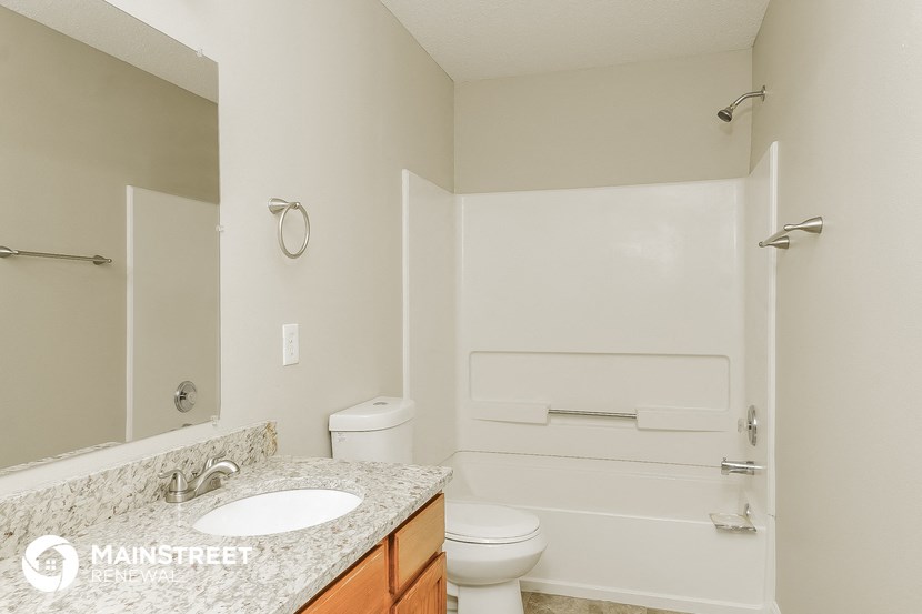 a bathroom with a sink and a toilet and a bath tub