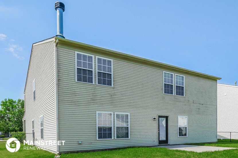 the outside of a white house with a blue sky