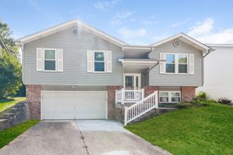 a gray house with a white garage door