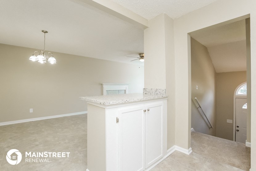 the kitchen and living room of an empty house