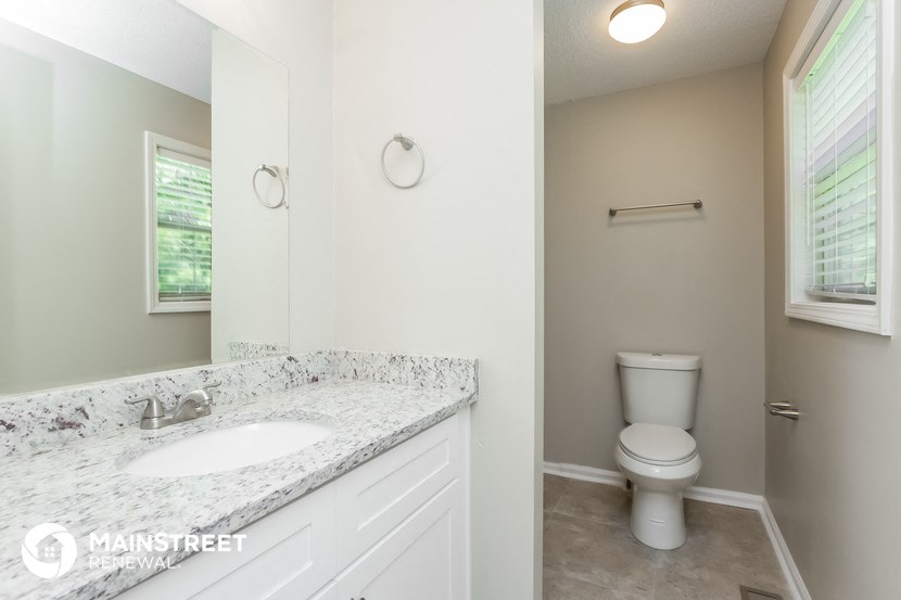 a bathroom with a sink and a toilet and a mirror