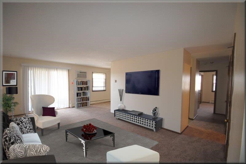 a living room with a television on the wall