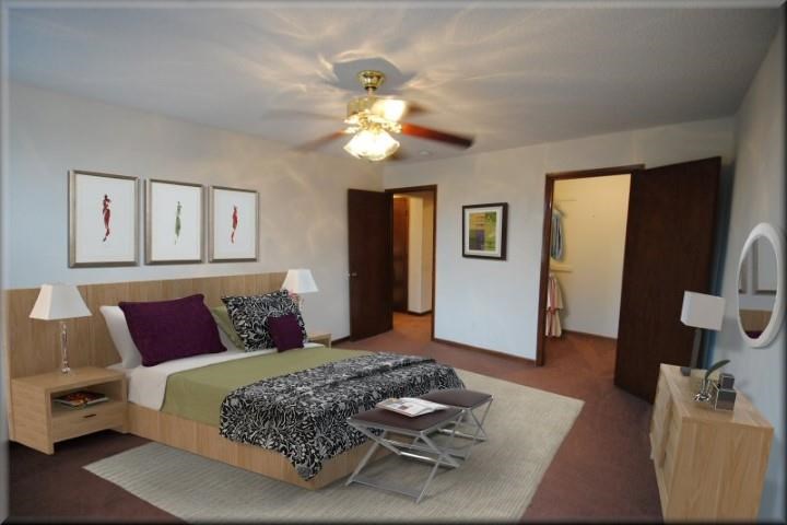 a bedroom with a bed and a ceiling fan