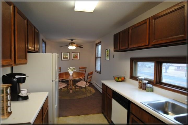 a kitchen with a dining room table and a refrigerator