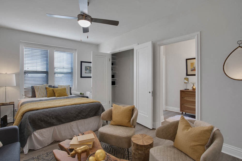 a bedroom with a bed and a ceiling fan