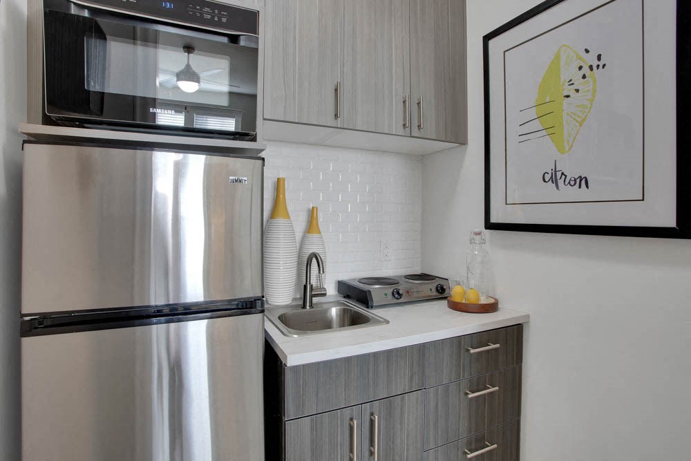 a kitchen with a sink and a refrigerator