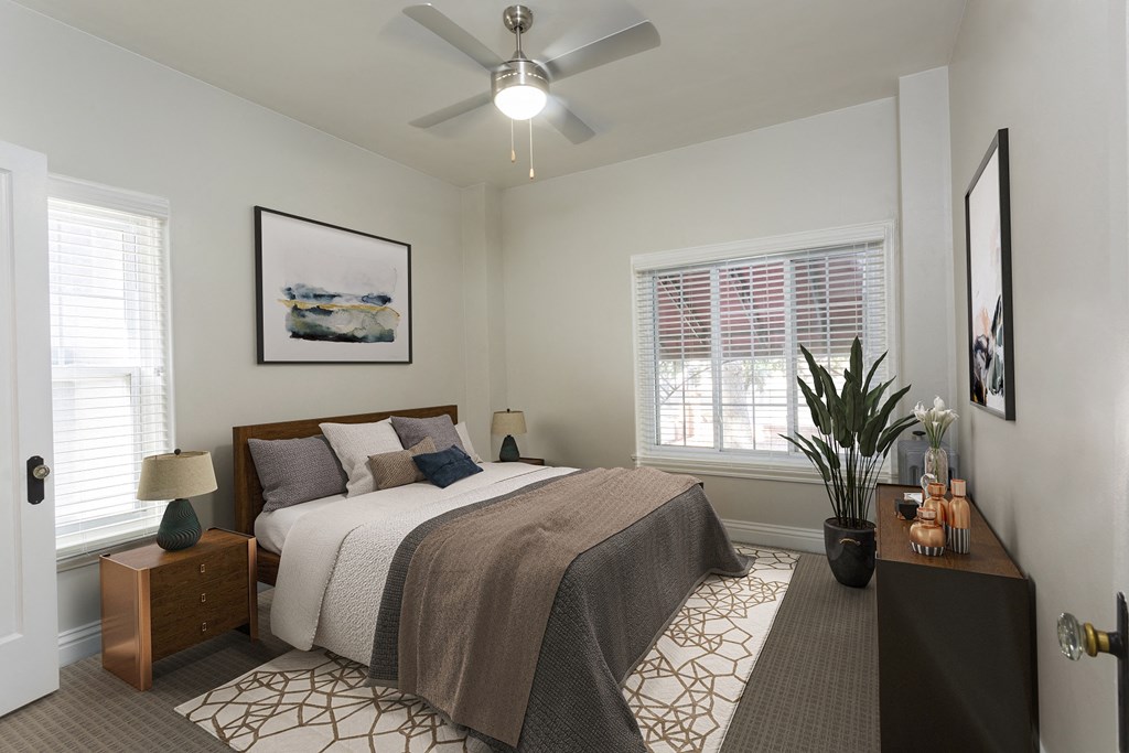 a bedroom with a bed and a ceiling fan