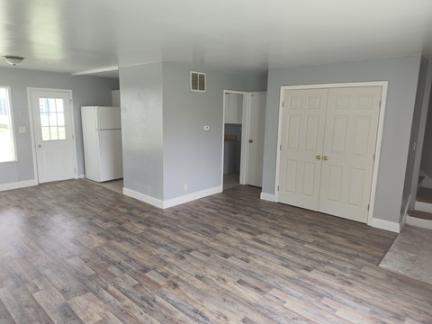 A room with a wooden floor and white walls.