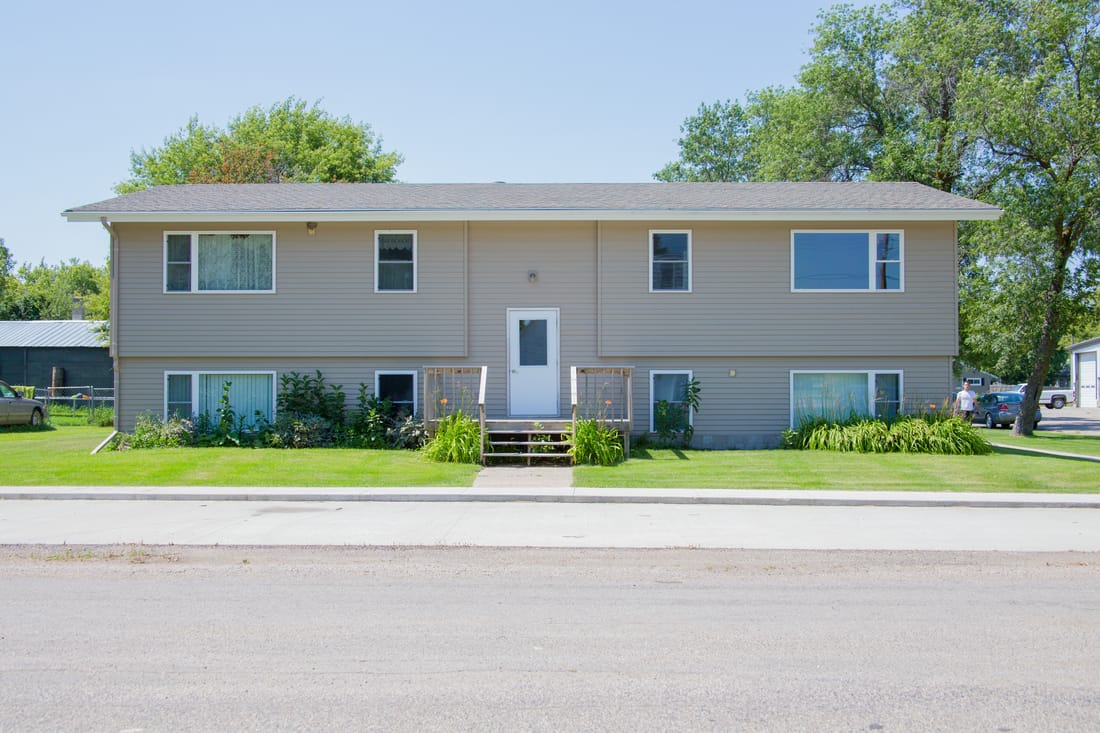 A two-story house with a front porch and a garage.