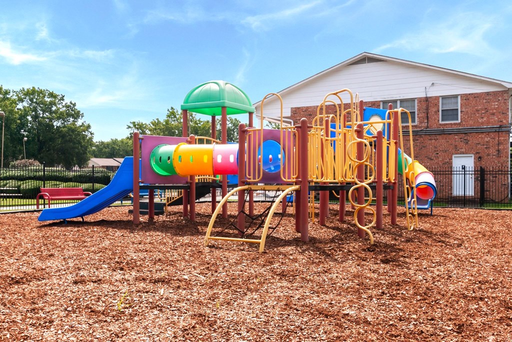 A playground with a slide, swings, and a climbing frame.