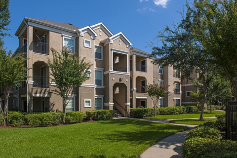 A large, well-maintained apartment complex with multiple buildings and green lawns.