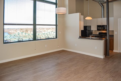A kitchen area with a window overlooking a bridge.