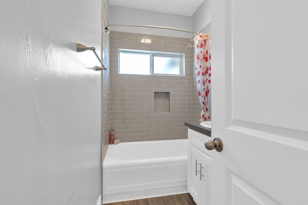 a small bathroom with a shower and a bath tub