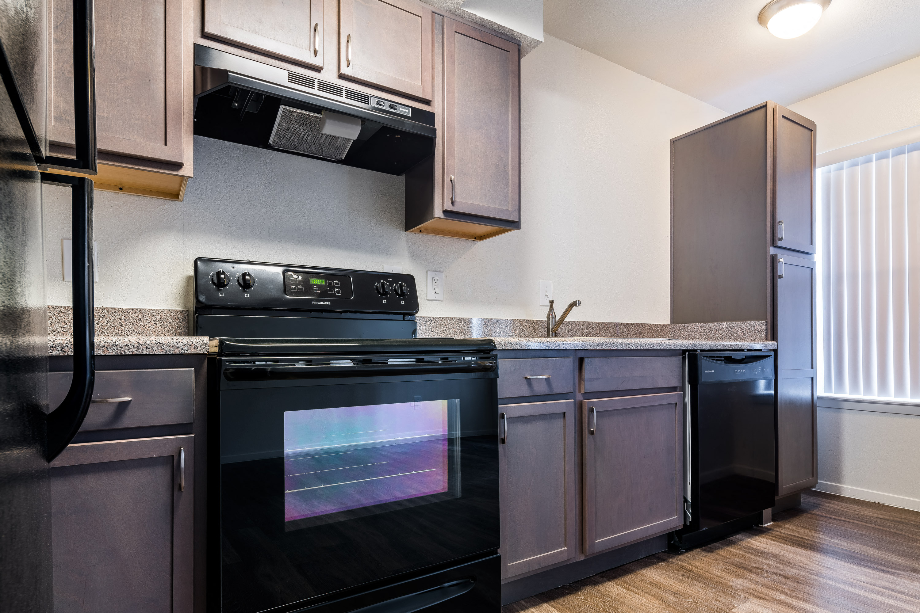 a kitchen with stainless steel appliances and a black stove and refrigerator