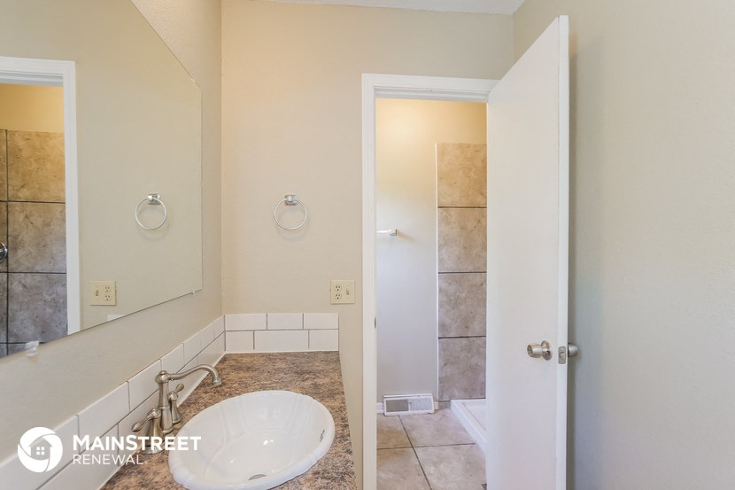 a bathroom with a sink and a mirror and a shower